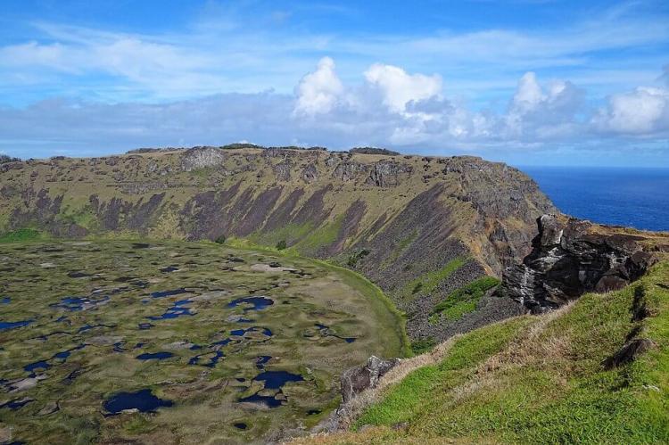 View from the west side of the crater at Rano Kau, looking towards the southern side of the crater, where much of the crater wall has collapsed into the sea. Easter Island, Chile