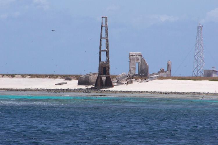 Ruins of the old lighthouse on Brazil's Rocas Atoll, with the new lighthouse in the background