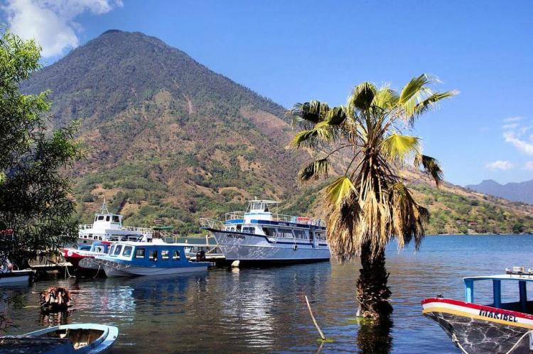 Boats on Lake  Atitlan with volcano in background, Guatemala