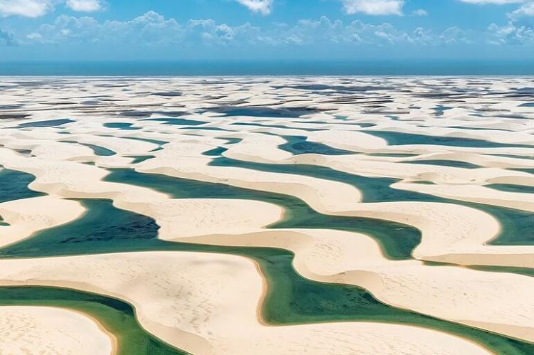 Fresh water collecting in the valleys between sand dunes in the Lençóis Maranhenses National Park in Brazil