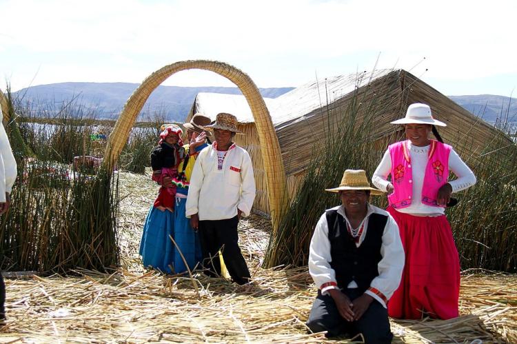 Uros people in traditional dress, on their floating island, Lake Titicaca, Peru