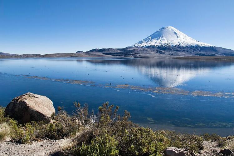 Snow-capped volcano Parinacota reflected in Lake Chungará, Lauca National Park, Chile