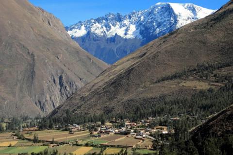 The eternal snows of the Andes rise above the Sacred Valley near Ollantaytambo, Peru